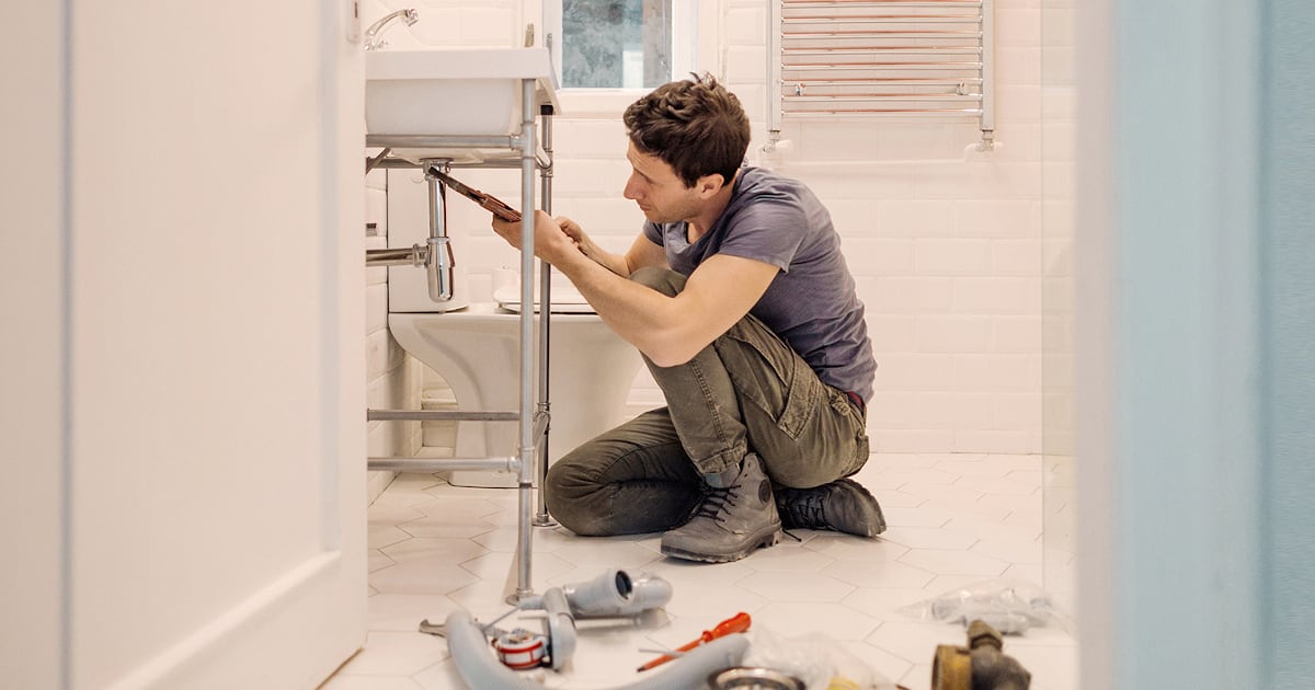 A man repairing his sink 