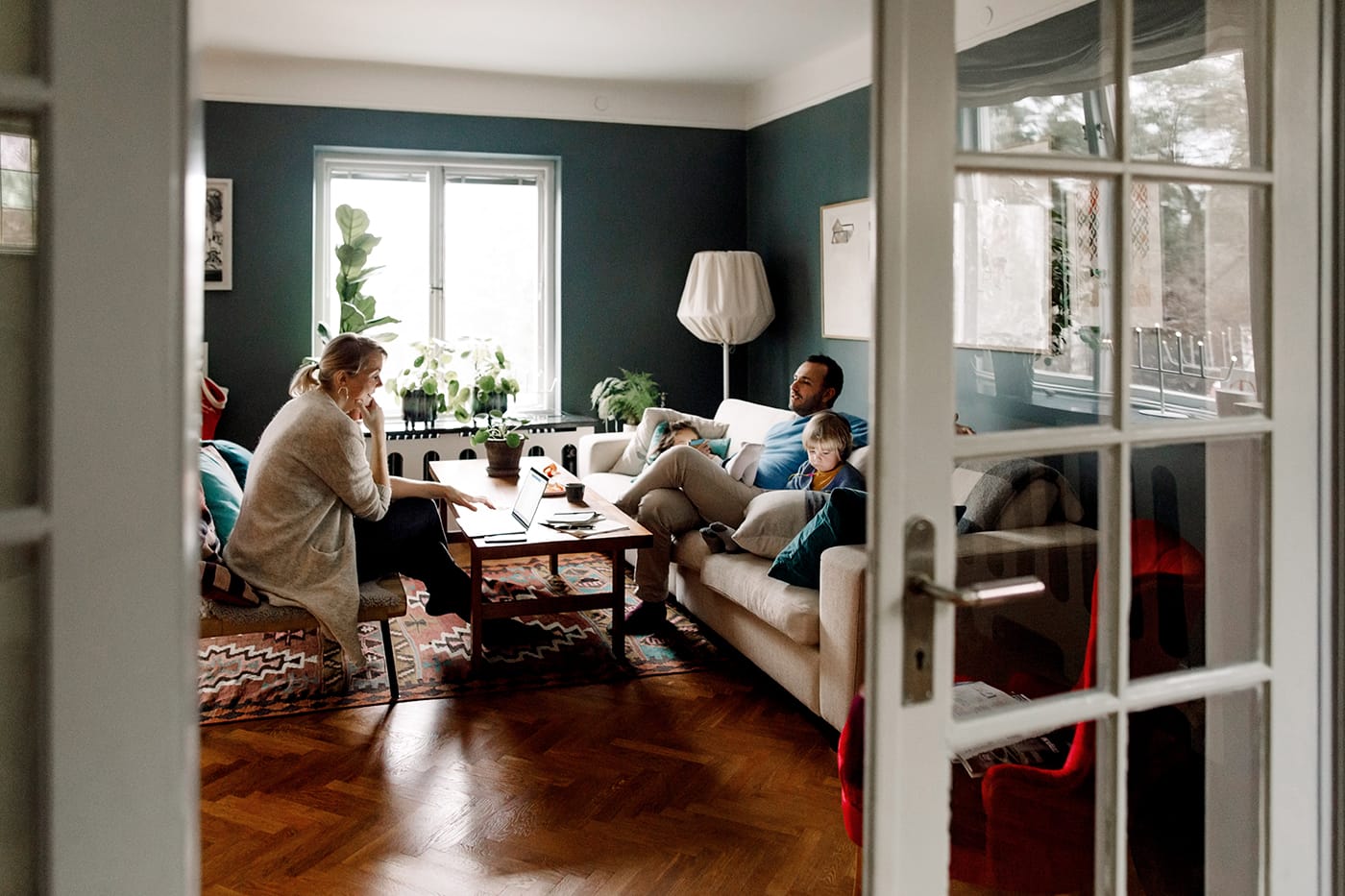 Eine Familie sitzt in ihrem Wohnzimmer.