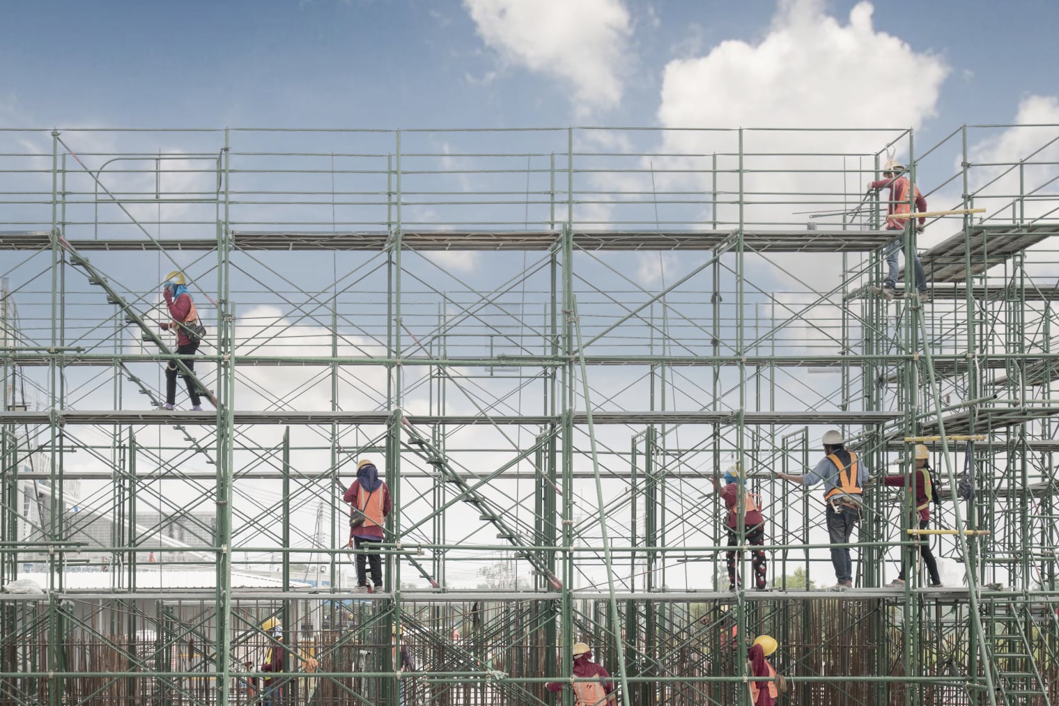 Several workers on scaffolding